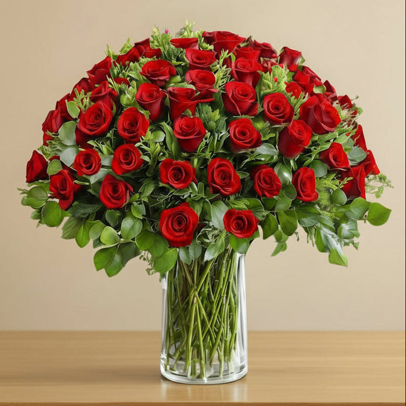 Arrangement of 100 red roses in a glass vase