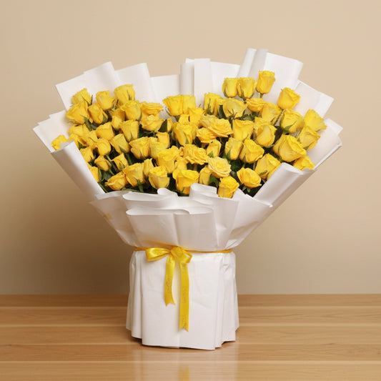 Bouquet of 100 yellow roses wrapped in white paper with a yellow ribbon
