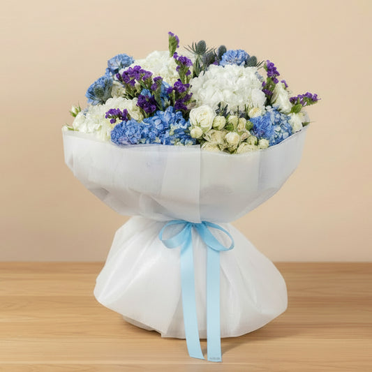 Blossom Haven mixed flower bouquet with white and blue hydrangea, white spray roses, eryngium and statice, available for same-day delivery in Dubai
