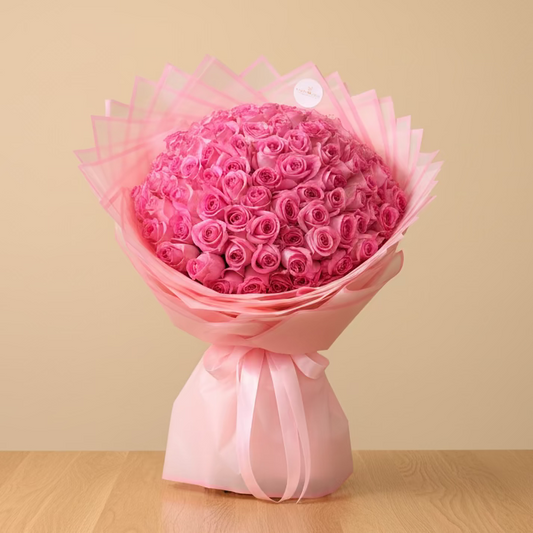 Large bouquet of pink roses wrapped in pink paper