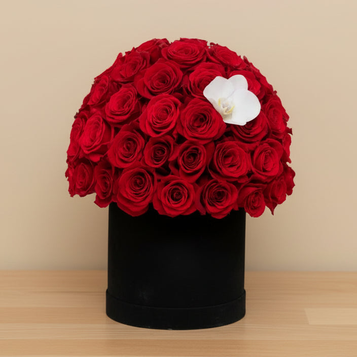 red roses in a black round box