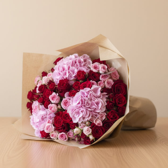 Bouquet of hydrangea and roses wrapped in brown paper