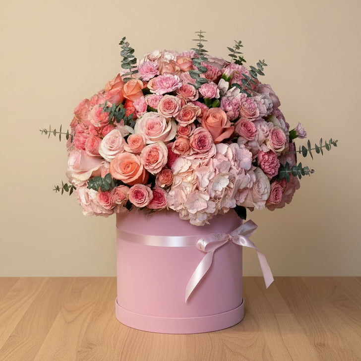 A premium flower box arrangement featuring pink hydrangeas, spray roses, and pink chrysanthemums for delivery in Dubai.