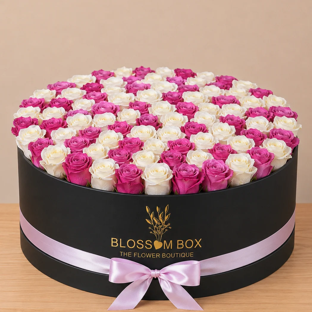 A grand arrangement of 100 fresh white and purple roses in a luxury black box