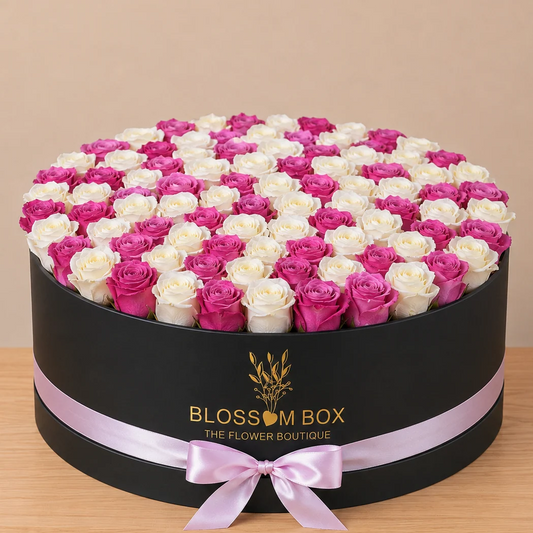 A grand arrangement of 100 fresh white and purple roses in a luxury black box