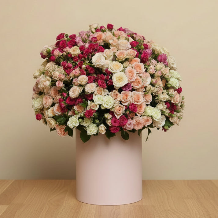 multicolored spray roses in a pink box
