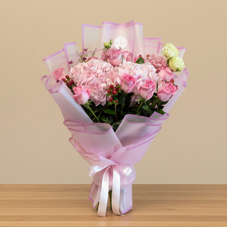 A bouquet of pink roses and hydrangeas