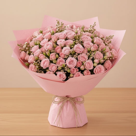 Bouquet of pink spray roses wrapped in pink paper